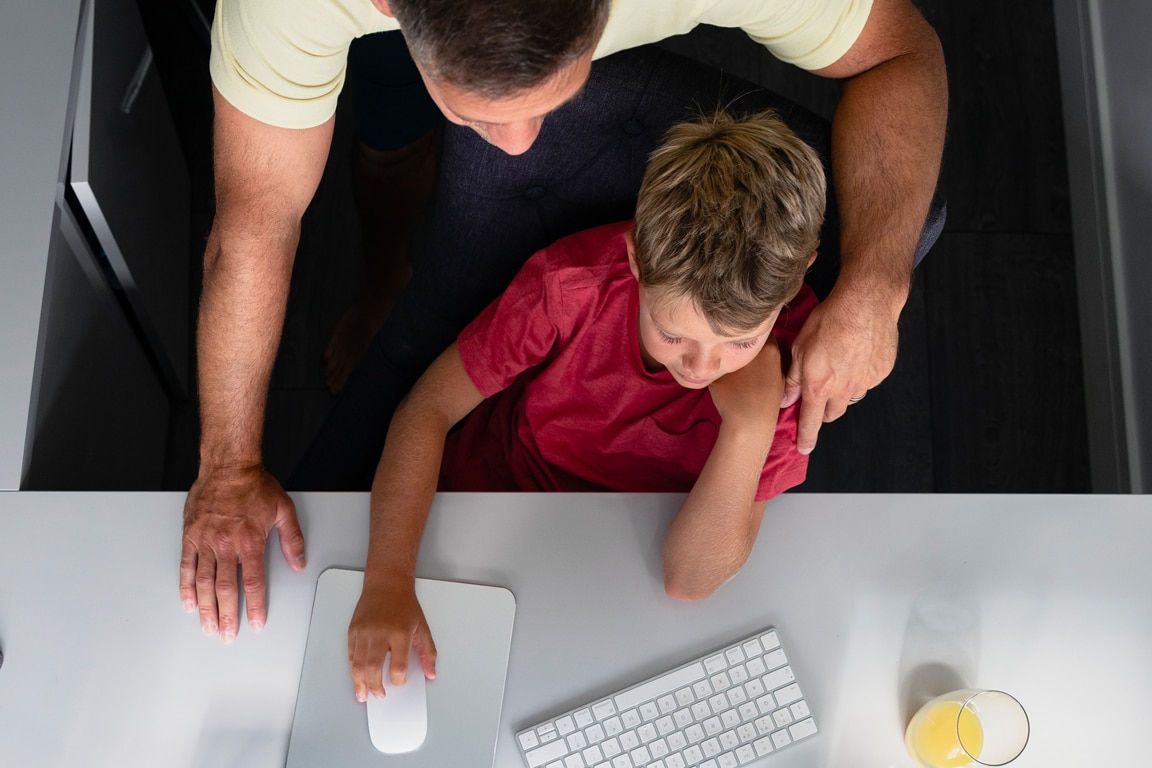 Father and son using a computer