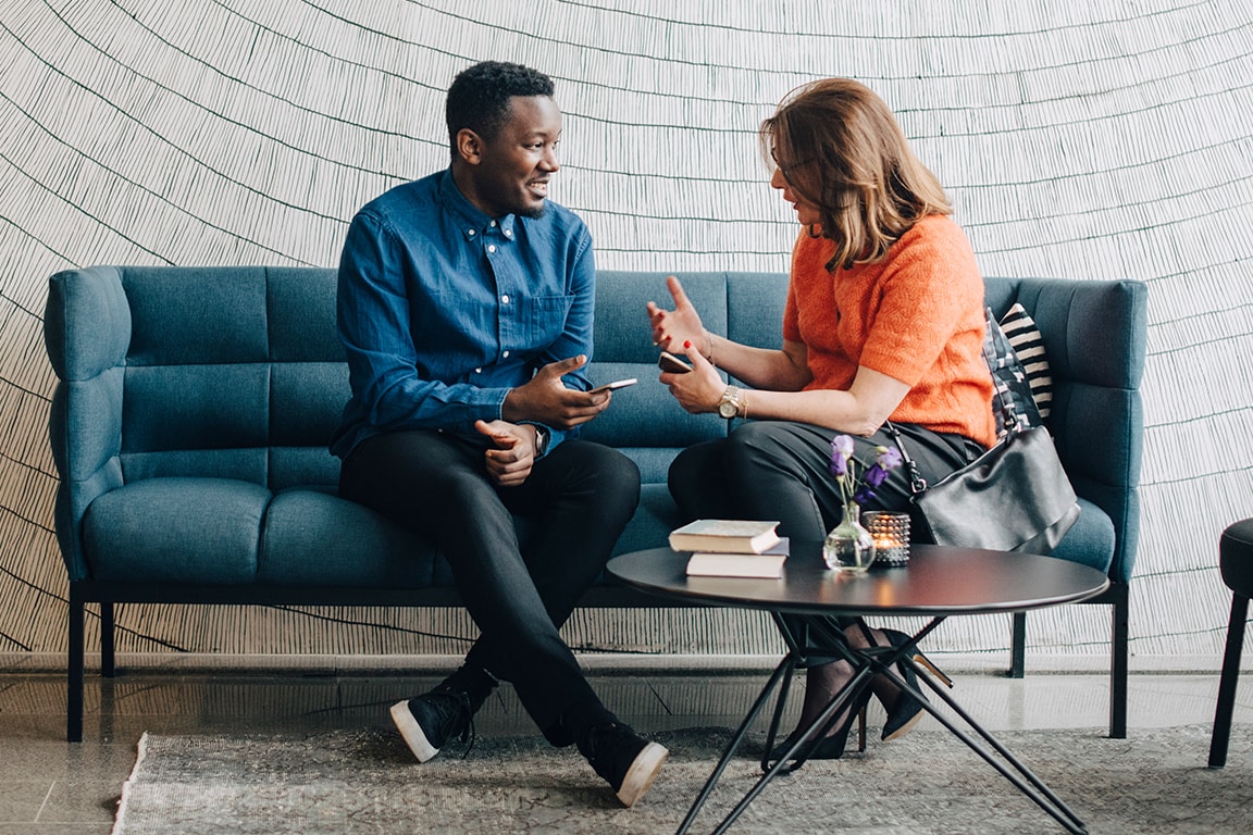 couple talking while sitting on couch