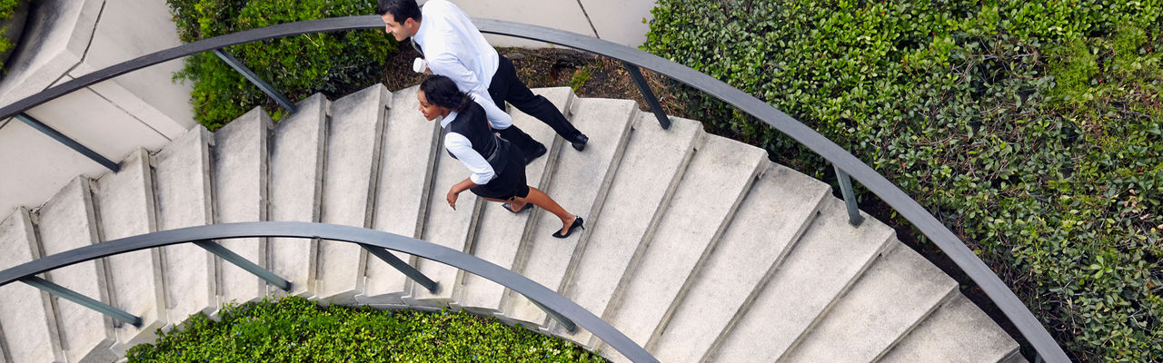 Business Couple Walking Up Stairs