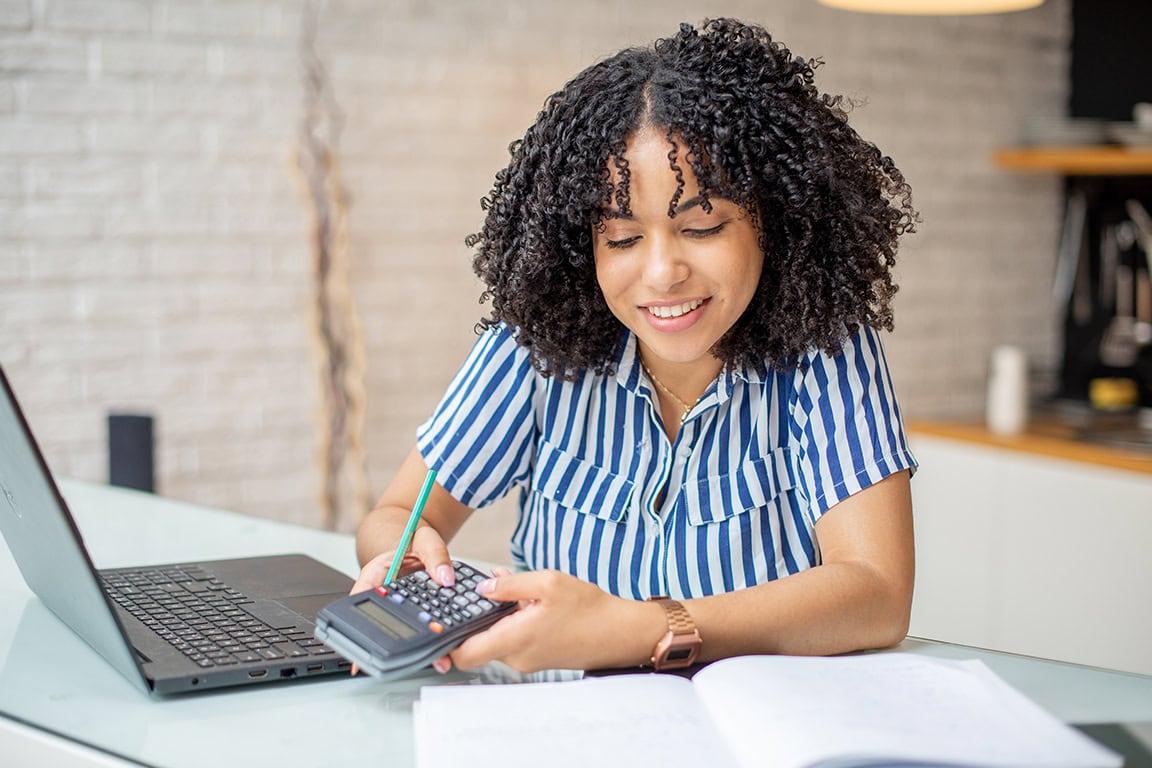 Happy women using a calculator