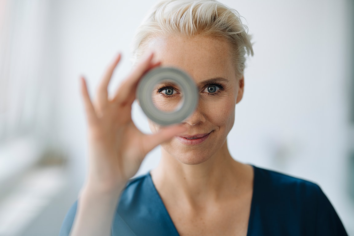 woman looking through a round shape