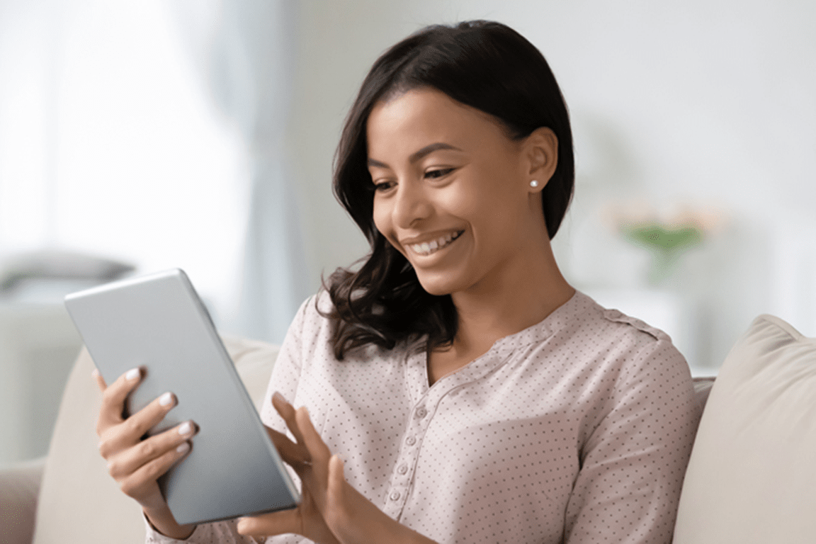 Happy woman looking at an iPad